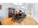 Bright dining room features hardwood floors and a wooden table with six chairs at 3529 High Hampton Cir, Tampa, FL 33610