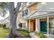 Two-story townhome with a red door and walkway at 3529 High Hampton Cir, Tampa, FL 33610