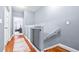 Upper hallway with wood floors, baby gate, and access to bedrooms at 3529 High Hampton Cir, Tampa, FL 33610