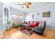 Living room with red sofa, green couch, and hardwood floors at 3529 High Hampton Cir, Tampa, FL 33610