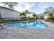 Community pool with brick patio and lounge chairs at 3529 High Hampton Cir, Tampa, FL 33610