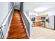 Wooden stairs leading to the second floor, with kitchen view at 3529 High Hampton Cir, Tampa, FL 33610
