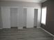 Spacious bedroom with two closets and wood-look flooring at 3722 Spinnaker Dr, Tampa, FL 33611