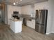 Modern kitchen with white cabinets, stainless steel appliances and island at 3722 Spinnaker Dr, Tampa, FL 33611