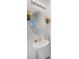 Small bathroom with pedestal sink, oval mirror, and window at 3830 Vignoble Ln, Brandon, FL 33511