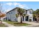 Gray two-story townhome with a side view showcasing landscaping at 3830 Vignoble Ln, Brandon, FL 33511