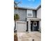 Gray two-story townhome with a two-car garage and landscaping at 3830 Vignoble Ln, Brandon, FL 33511