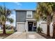 Two-story townhome with gray exterior, two-car garage, and palm trees at 3830 Vignoble Ln, Brandon, FL 33511