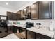Dark wood kitchen cabinets, granite countertops, and appliances at 3830 Vignoble Ln, Brandon, FL 33511