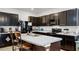 Modern kitchen with dark cabinetry and granite countertops at 3830 Vignoble Ln, Brandon, FL 33511