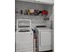 Bright laundry room with washer, dryer, and ample shelving at 3830 Vignoble Ln, Brandon, FL 33511