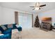 Living room featuring a blue sectional sofa and fireplace at 3830 Vignoble Ln, Brandon, FL 33511