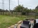 Spacious fenced backyard with green grass, an outdoor seating area and space to entertain at 442 Country Club Dr, Oldsmar, FL 34677