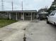 Exterior view of single-story house with a boat and truck parked in the long driveway at 442 Country Club Dr, Oldsmar, FL 34677