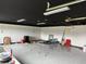 Large garage space with black ceiling, white walls and overhead lighting, ready for customization at 442 Country Club Dr, Oldsmar, FL 34677