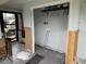 Unfinished laundry room features light gray walls, open shelving, and essential utility connections at 442 Country Club Dr, Oldsmar, FL 34677
