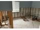 Living room with exposed wall studs, bright window, and open space, awaiting renovation at 442 Country Club Dr, Oldsmar, FL 34677