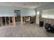 Living room awaiting renovation, featuring exposed wall studs, large windows, and bright atmosphere at 442 Country Club Dr, Oldsmar, FL 34677