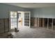 Spacious living room awaiting renovation, featuring double doors leading to an outdoor area at 442 Country Club Dr, Oldsmar, FL 34677