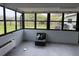 Enclosed sun room with lots of windows, and a view of the exterior yard space at 442 Country Club Dr, Oldsmar, FL 34677