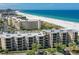 Aerial view of beachfront condo building with ocean and beach at 4510 Gulf Blvd # 408, St Pete Beach, FL 33706