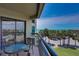 Balcony with partial ocean view and table at 4510 Gulf Blvd # 408, St Pete Beach, FL 33706