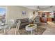 Living room with leather sofa, kitchen, and ocean view at 4510 Gulf Blvd # 408, St Pete Beach, FL 33706
