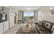 Bright living room with ocean view, leather sofa, and dining area at 4510 Gulf Blvd # 408, St Pete Beach, FL 33706