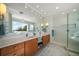 Elegant bathroom with double vanity, large mirror, and walk-in shower at 477 20Th Ave, Indian Rocks Beach, FL 33785