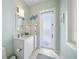 Small bathroom with white vanity and frosted glass door at 477 20Th Ave, Indian Rocks Beach, FL 33785