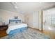 Main bedroom with plush bed, blue accents, and access to en-suite bath at 477 20Th Ave, Indian Rocks Beach, FL 33785