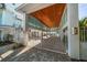Covered carport with gated entry and brick pavers at 477 20Th Ave, Indian Rocks Beach, FL 33785