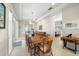 Bright dining room with large table and seating for ten, hardwood floors, and access to sliding doors at 477 20Th Ave, Indian Rocks Beach, FL 33785