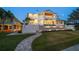 Two-story waterfront home with pool and landscaped yard at dusk at 477 20Th Ave, Indian Rocks Beach, FL 33785