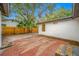 Spacious backyard, brick patio, and a view of the home's exterior at 505 Jefferson S Ave, Oldsmar, FL 34677