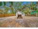 Large backyard with detached garage, fire pit and basketball court at 505 Jefferson S Ave, Oldsmar, FL 34677