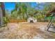 Screened-in porch, large backyard, mature trees, and a fire pit at 505 Jefferson S Ave, Oldsmar, FL 34677