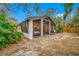 Home exterior showcasing a screened patio and backyard at 505 Jefferson S Ave, Oldsmar, FL 34677