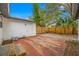 Large backyard with brick patio, detached garage, and wood fence at 505 Jefferson S Ave, Oldsmar, FL 34677