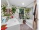 Spa-like bathroom with a soaking tub and plenty of plants at 505 Jefferson S Ave, Oldsmar, FL 34677