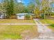 Ranch-style home with a green roof and a spacious yard at 505 Jefferson S Ave, Oldsmar, FL 34677