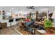 Bright living room with hardwood floors, comfy seating, and a view into the kitchen at 505 Jefferson S Ave, Oldsmar, FL 34677