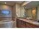 Double vanity and granite countertops highlight this elegant bathroom at 530 S Gulfview Blvd # 205, Clearwater, FL 33767