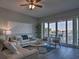 Bright living room with water views, comfortable seating, and hardwood floors at 530 S Gulfview Blvd # 205, Clearwater, FL 33767