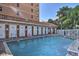 Refreshing community pool with multiple lounge chairs and nearby restrooms at 530 S Gulfview Blvd # 205, Clearwater, FL 33767