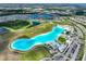 Aerial view of community with lagoon at 5322 Windy Grove Dr, Wimauma, FL 33598