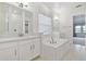 Main bathroom with soaking tub, double vanity, and walk-in shower at 5322 Windy Grove Dr, Wimauma, FL 33598