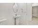 Simple bathroom with pedestal sink and oval mirror at 5322 Windy Grove Dr, Wimauma, FL 33598