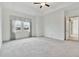 Spacious bedroom with carpet flooring and large windows at 5322 Windy Grove Dr, Wimauma, FL 33598