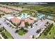 Aerial view of community including clubhouse, pool, and tennis courts at 5322 Windy Grove Dr, Wimauma, FL 33598